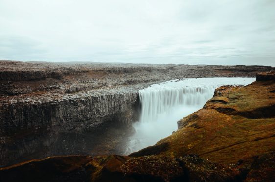 Dettifoss from the west rim in autumn, the water pouring over a long straight lip of basalt