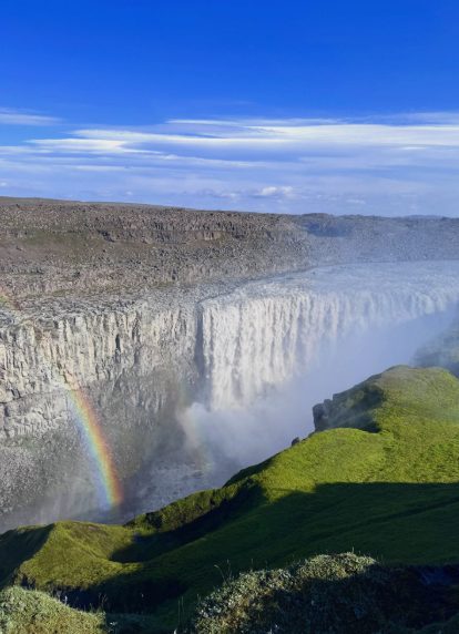 A rainbow standing in the spray at Dettifoss on a clear day