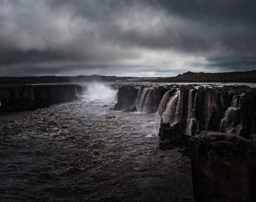 Selfoss from low down in the canyon, the river running away between basalt walls